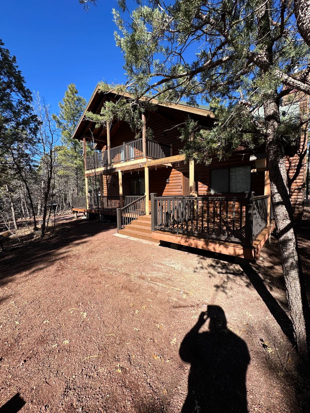 Two-story deck with composite stairs on a log home