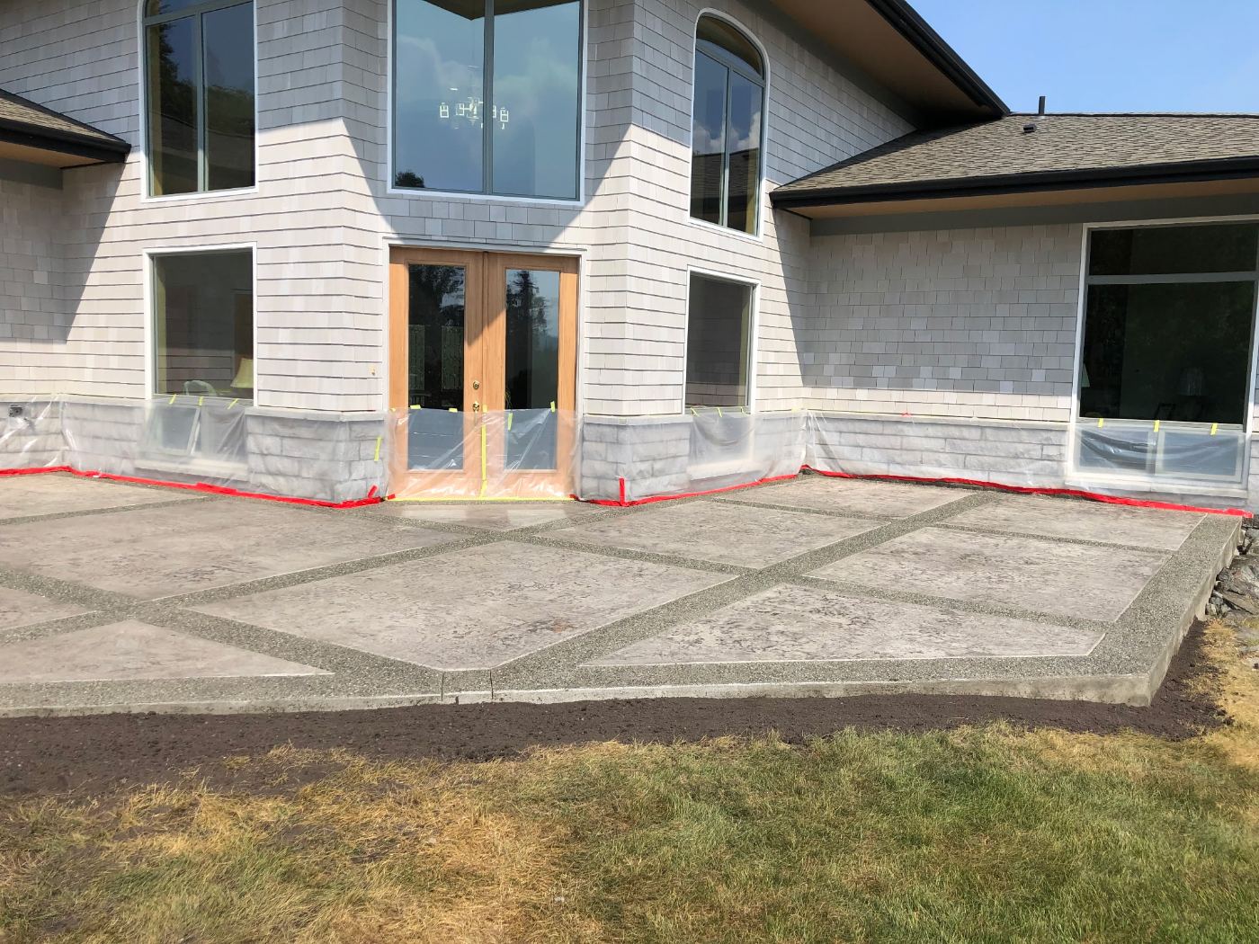 Large stamped patio with aggregate grid