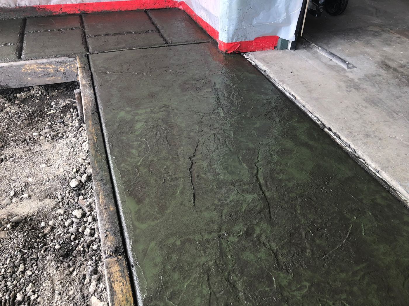 Colored stamped concrete during finishing