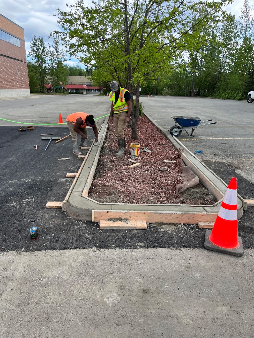 Crew forming a parking lot curb