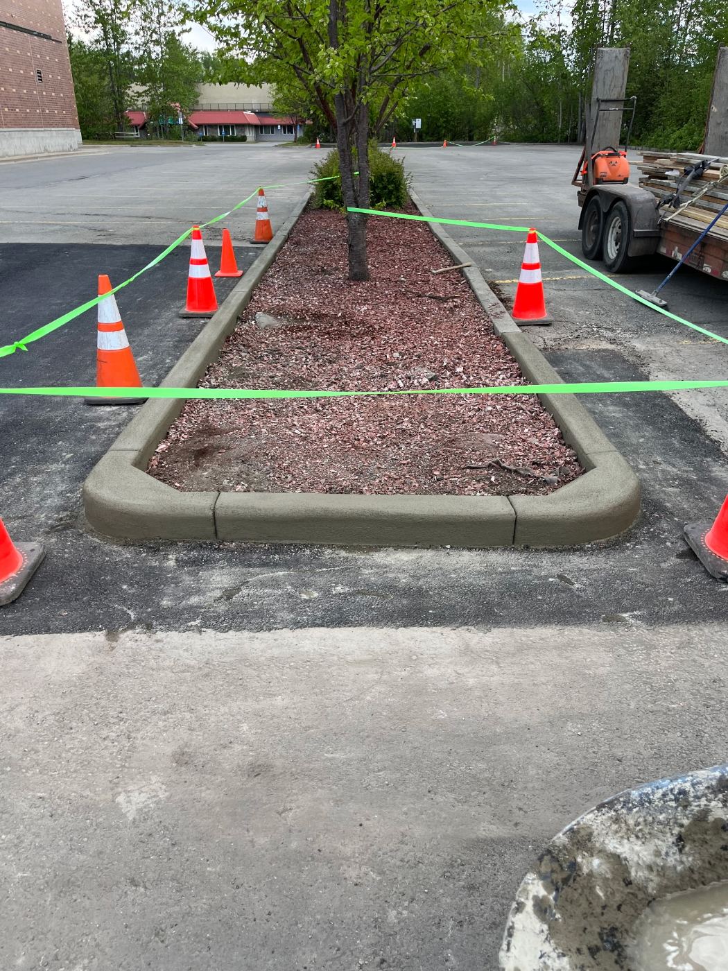 Finished concrete curb around a parking lot island